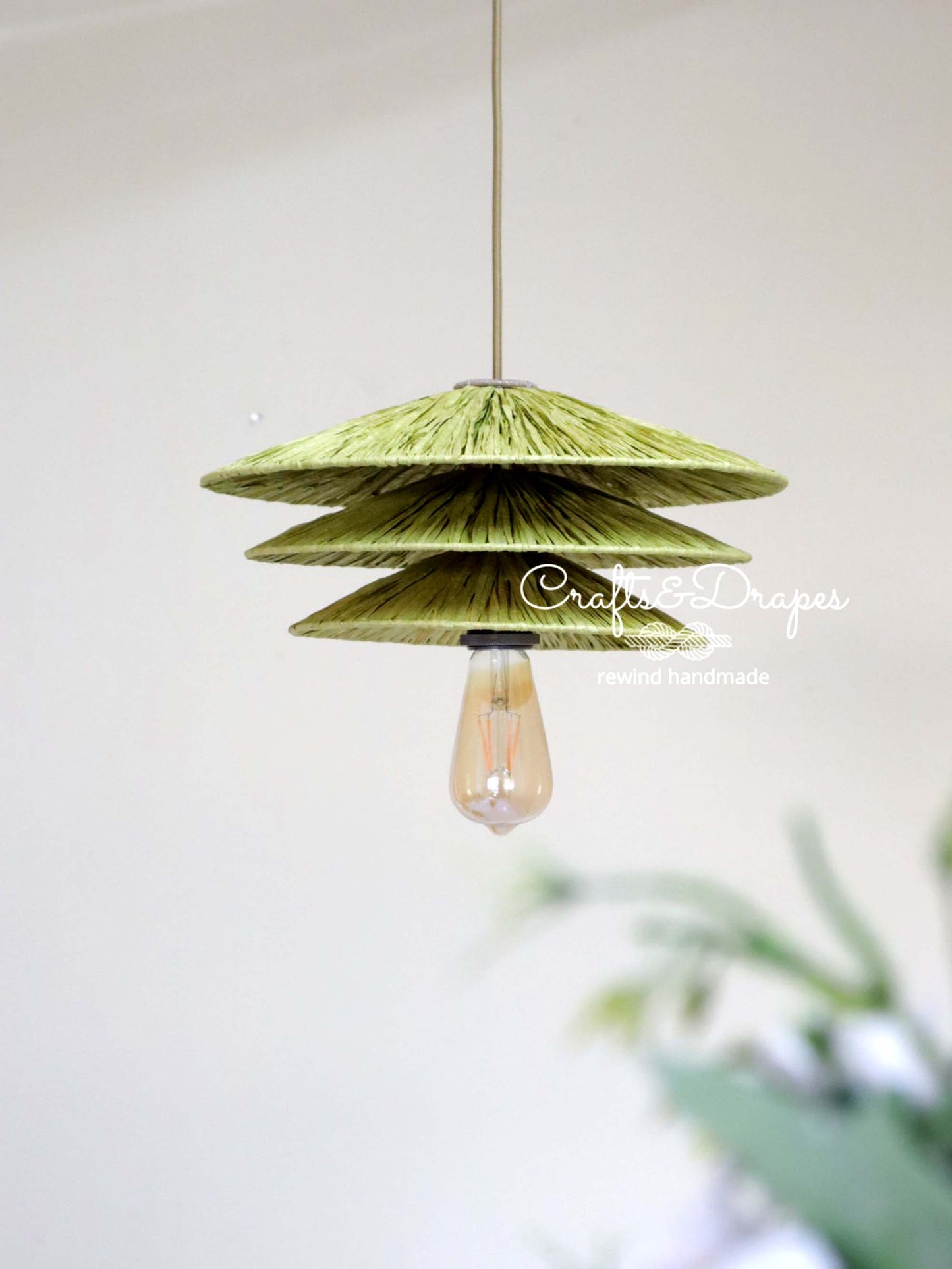 Artisanal paper raffia pendant lampshade for a natural and organic feel.