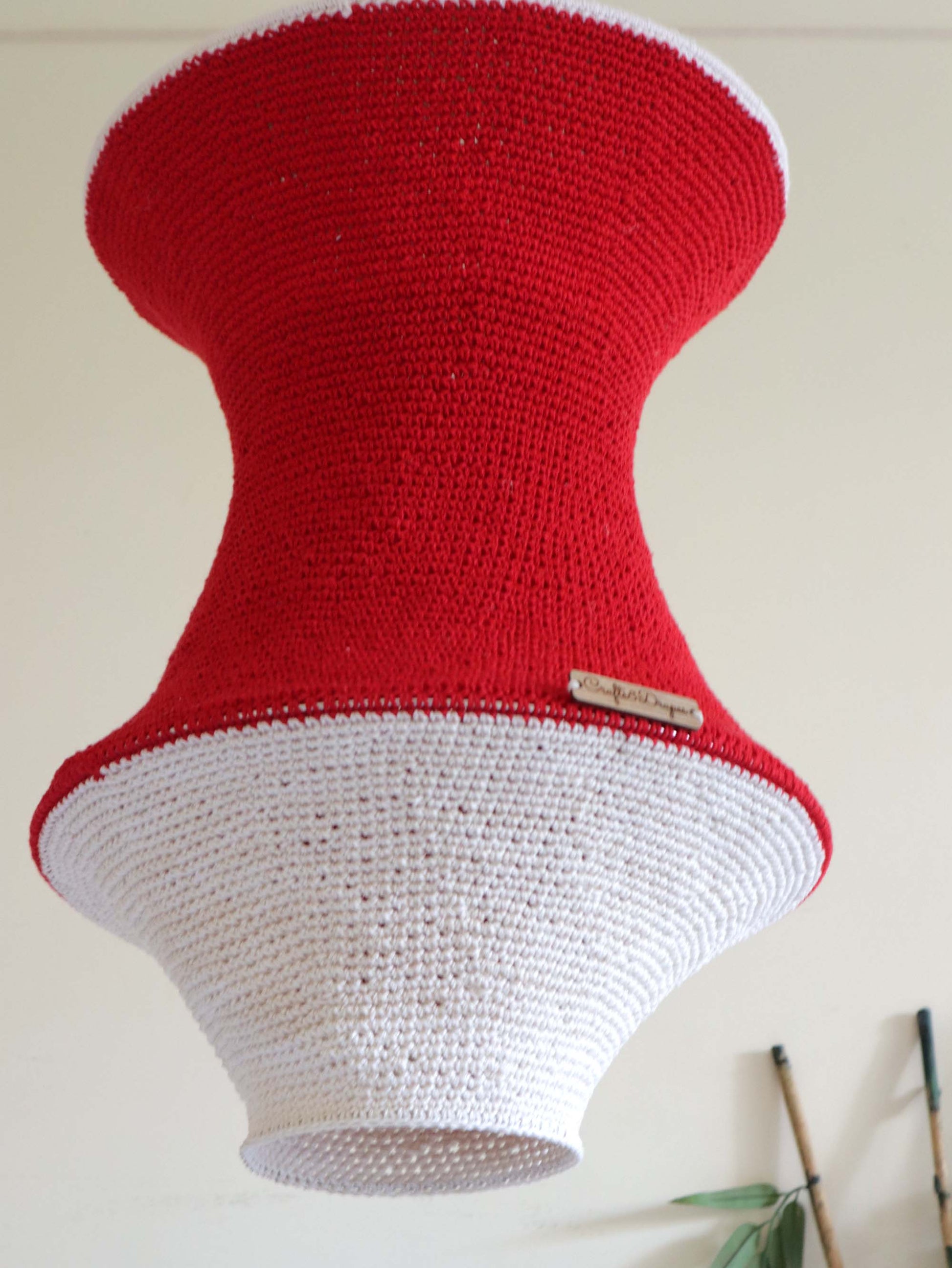  "Artisan-made handwoven red and ivory crochet light.